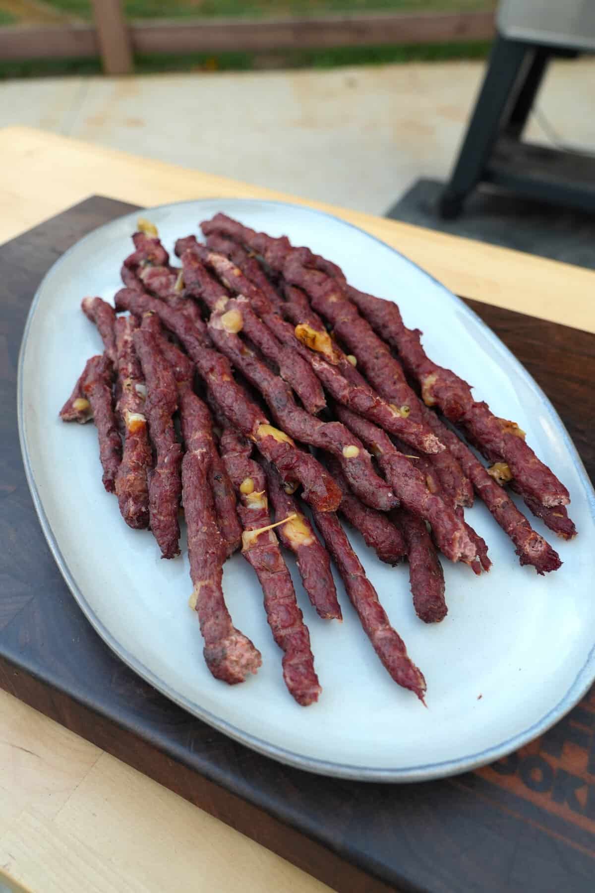 A plate of finished pizza beef sticks