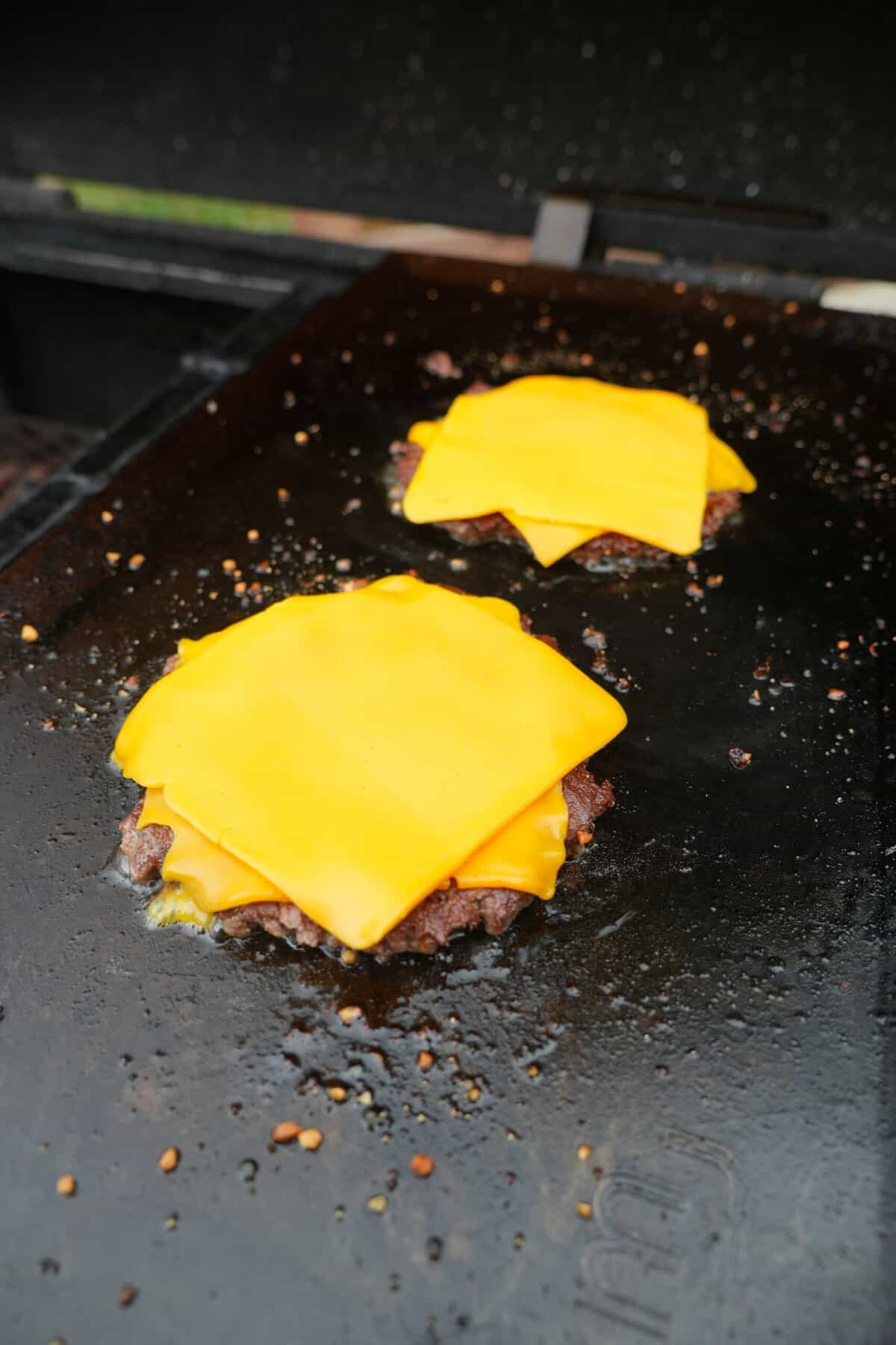 The Western BBQ Burger patties are shown topped with yellow American cheese.