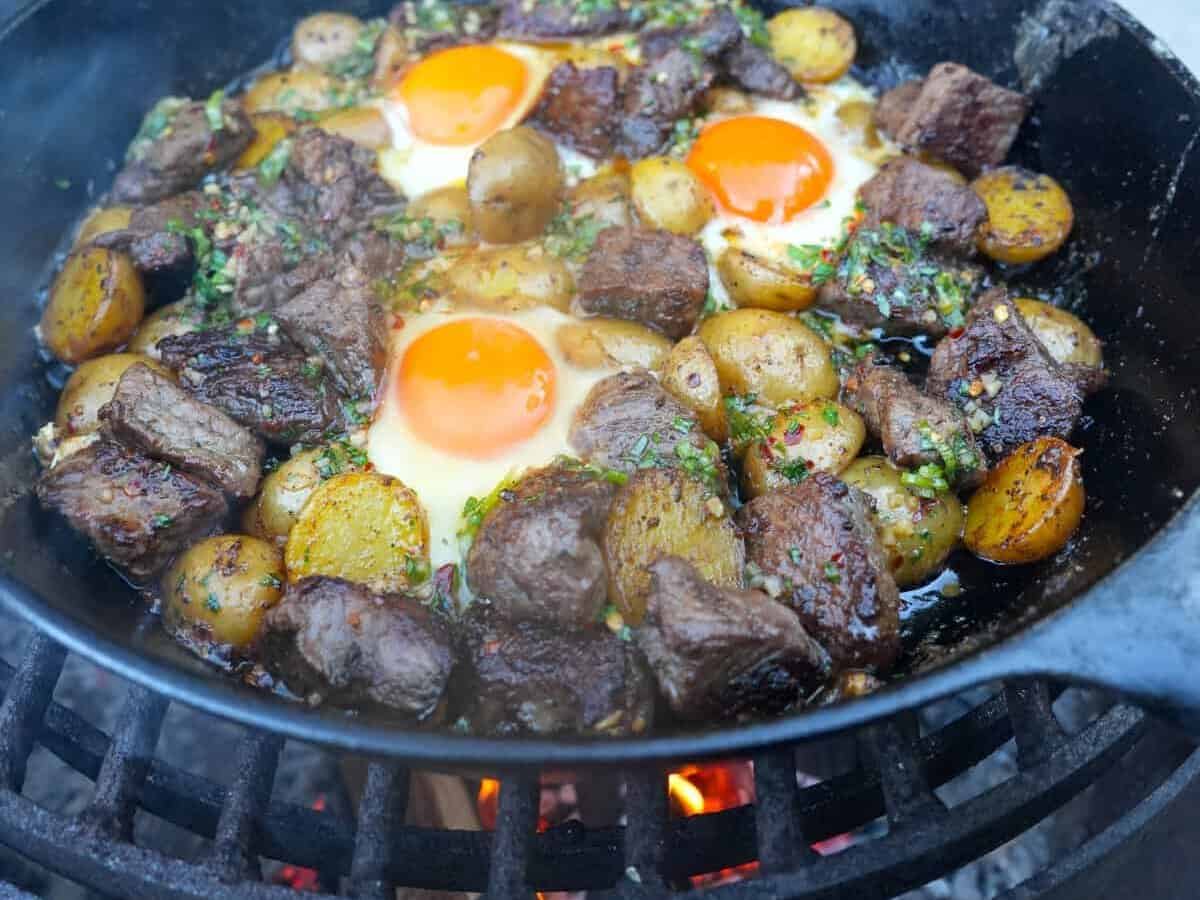 An alternative shot of the steak and eggs with honey cajun butter drizzled over the top.