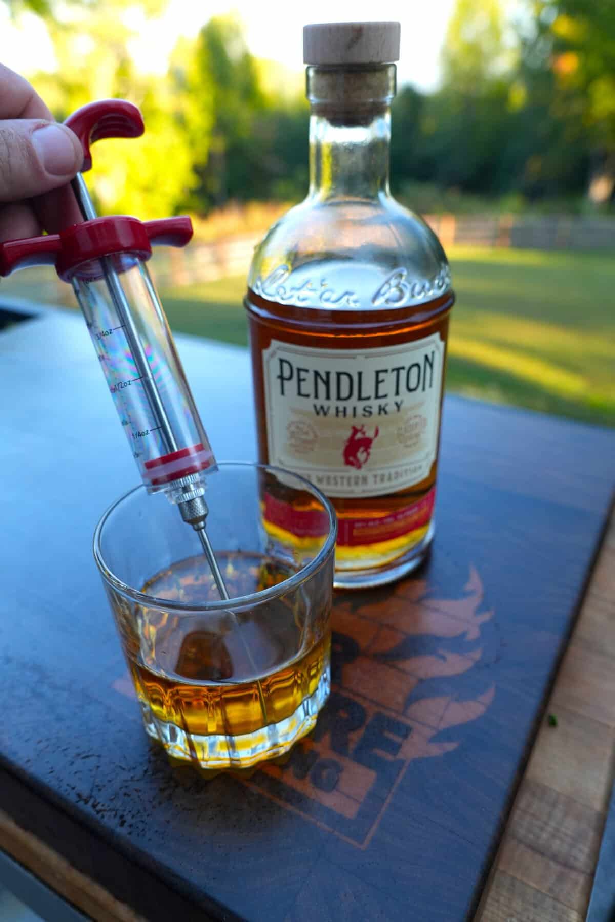 Shows a bottle of Pendleton Whisky with the meat inector
